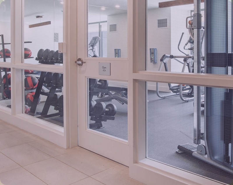 A locked gym (fitness center) door with access control system.